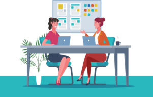 Stock photo of women in business attire speaking at a desk with their laptops out
